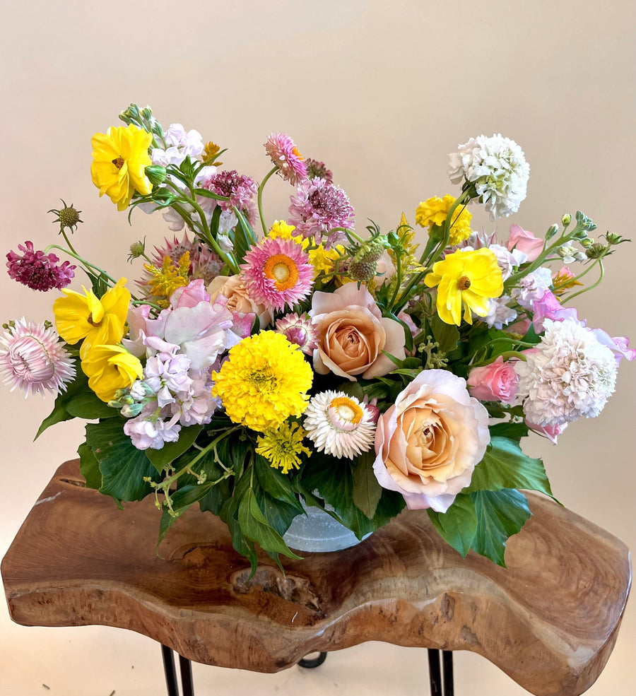 Pink white scabiosa, yellow butterfly ranunculus, peach roses, spray roses, strawflower in clear vase. Fall birthdays in Houston 