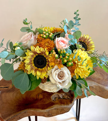 Quicksand roses, pink roses, sunflowers, autumn mums in basket, perfect birthday flowers in Houston.
