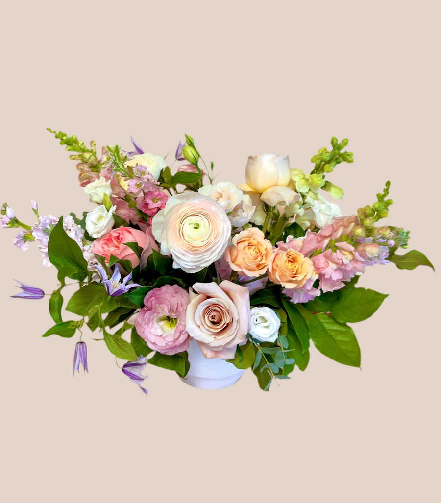 Valentine arrangement garden style with seasonal flowers in a white vase. Ready for delivery or pick-up in Houston this Valentine