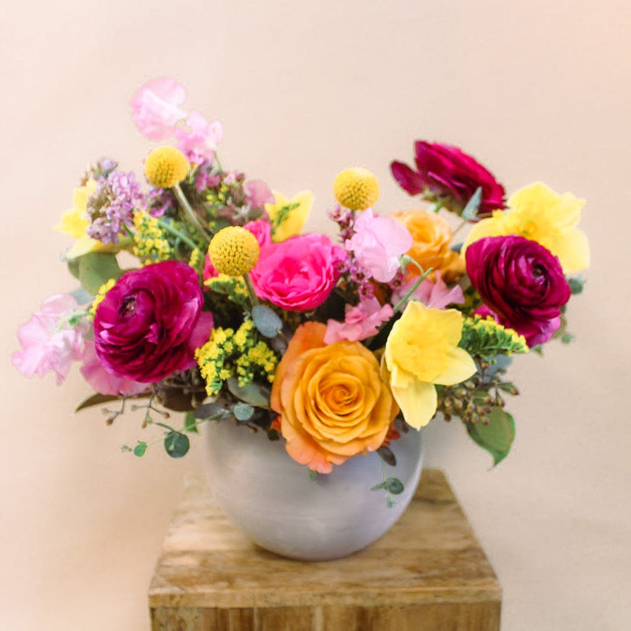 Roses, ranunculus, sweet pea, daffodils, billy balls, solidago, eucalyptus in a concrete ceramic bowl ready for any birthdays, anniversary, or celebrations in Houston