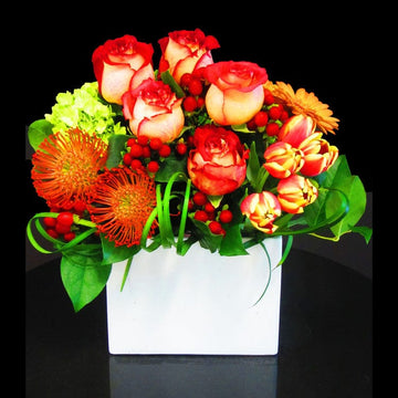 Peach and orange tropical flowers and orange gerbera, bicolored peach and tulips rich in bold colors for any occasion delivery or pickup in Houston.