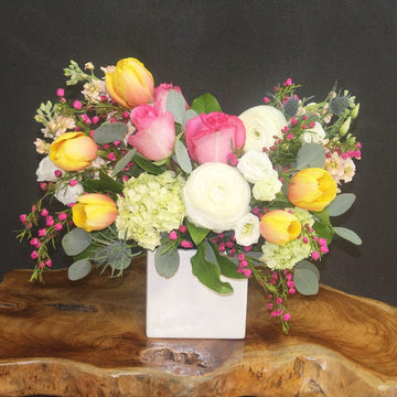 Delivery summer joy in Houston with yellow tulip, roses, peach stock and more. 