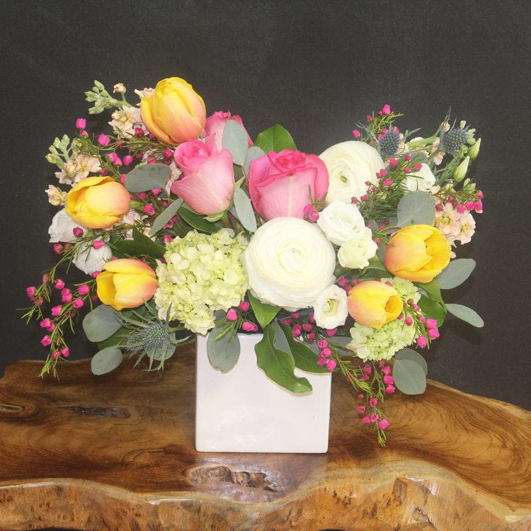 Delivery summer joy in Houston with yellow tulip, roses, peach stock and more. 