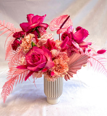 Valentine inspired arrangement with flex hot pink roses, light pink roses, hot pink anthuriums, antique carnations and a variety of preserved pink & filler flowers.