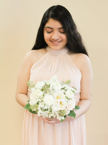 Nosegay bouquet includes ranunculus, lisianthus, spray roses, and classic roses. Wedding Elopement in Houston. Wedding bridal bouquet in Houston