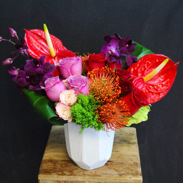 Purple orchids, lavender roses, proteas lush arrangement precious birthday flowers for the summer.